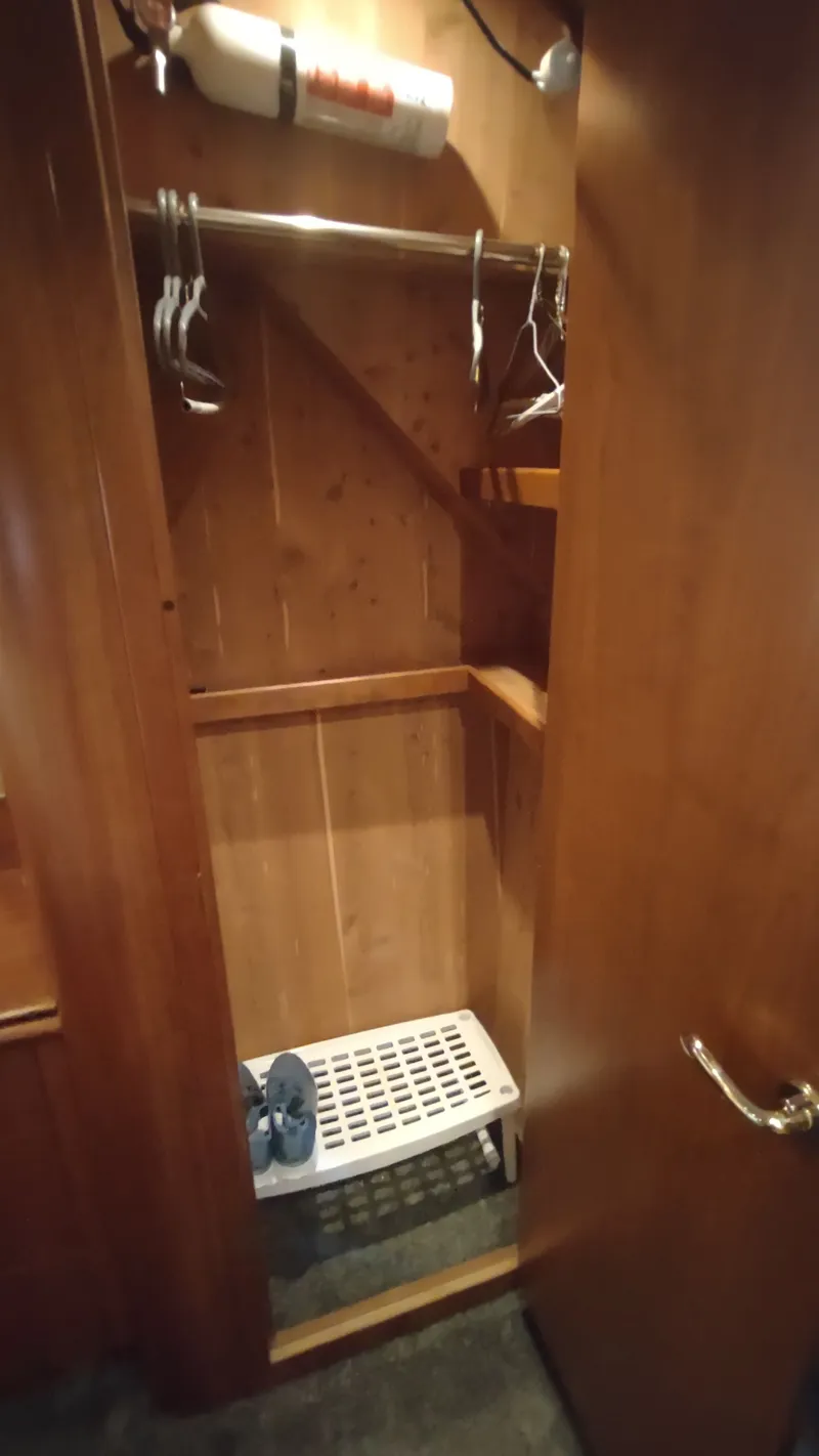 Slide: The Image of Wooden closet interior on 2001 Cruisers Yachts 4450 Express Motoryacht. - 37