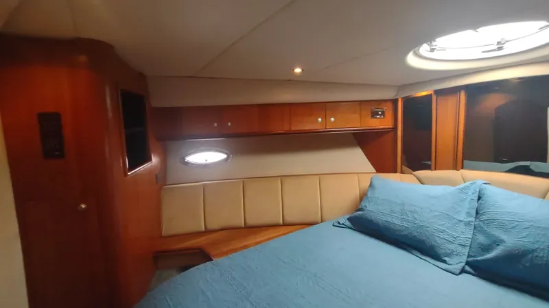 Slide: The Image of Luxurious cabin interior of 2001 Cruisers Yachts 4450 Express Motoryacht with blue bedding. - 42