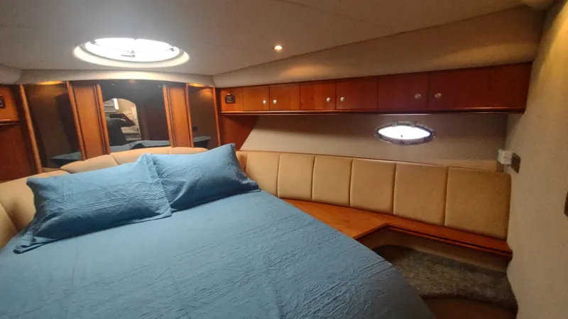 Slide: The Image of Luxurious cabin interior of 2001 Cruisers Yachts 4450 Express Motoryacht with cozy bed and porthole. - 43