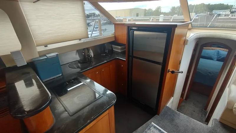 Slide: The Image of Luxurious 2001 Cruisers Yachts 4450 Express Motoryacht interior kitchen with modern amenities. - 5