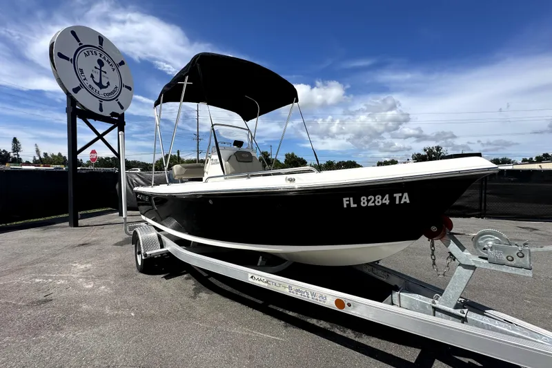 Slide: The Image of 2022 Key West 1720 Center Console boat on trailer under blue sky. - 0