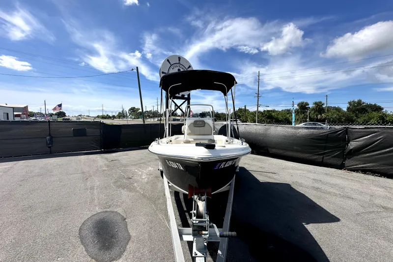 Slide: The Image of 2022 Key West 1720 Center Console boat on trailer under blue sky. - 1