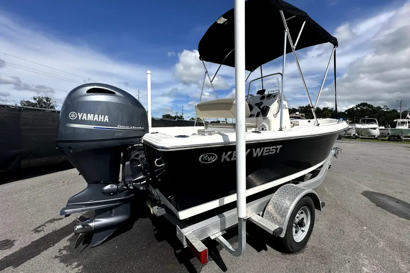 Slide: The Image of 2022 Key West 1720 Center Console boat on trailer under blue sky. - 11