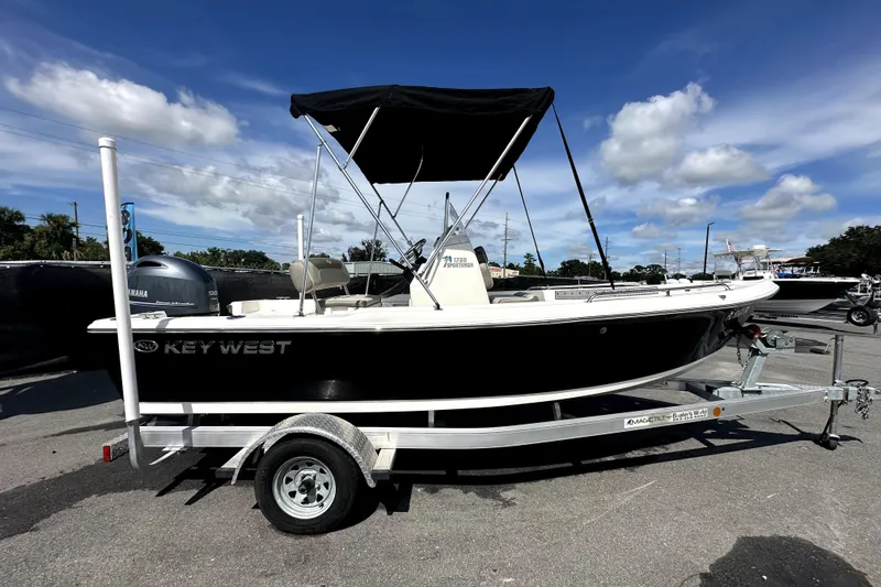 Slide: The Image of 2022 Key West 1720 Center Console boat on trailer under clear blue sky. - 12