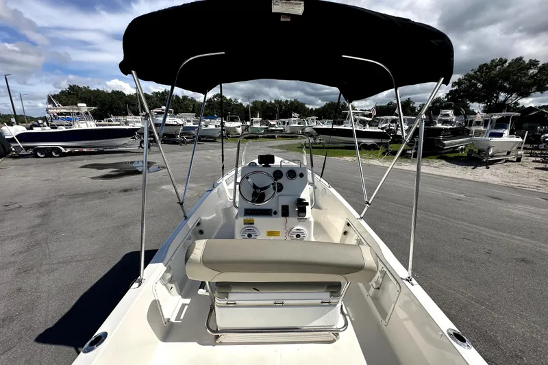 Slide: The Image of 2022 Key West 1720 Center Console boat with canopy in a marina setting. - 13