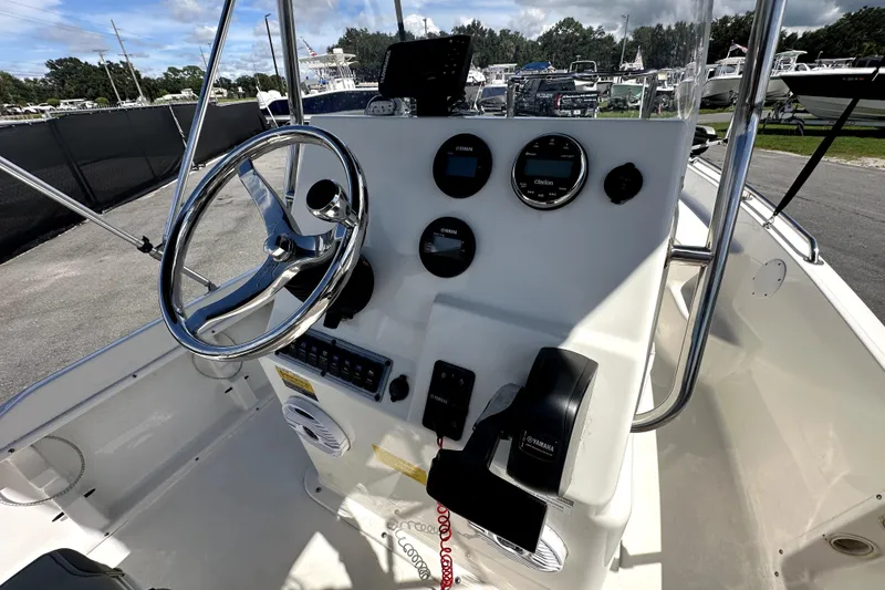 Slide: The Image of 2022 Key West 1720 Center Console boat dashboard with steering wheel and controls. - 19