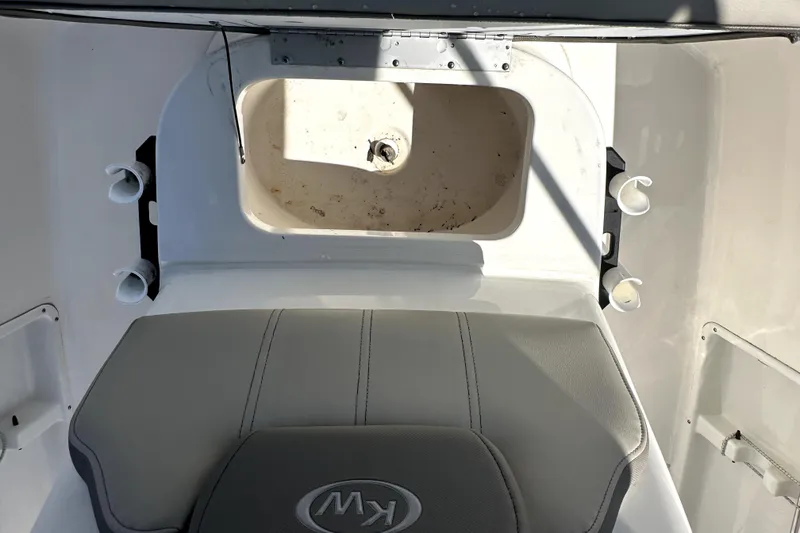 Slide: The Image of 2022 Key West 1720 Center Console boat interior with seating and storage compartment. - 22