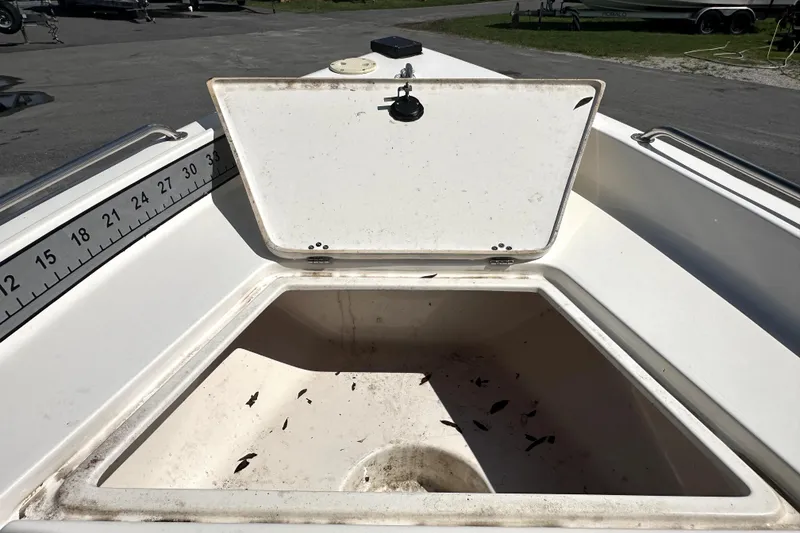 Slide: The Image of Open storage compartment on 2022 Key West 1720 Center Console boat, with measurement markings. - 26