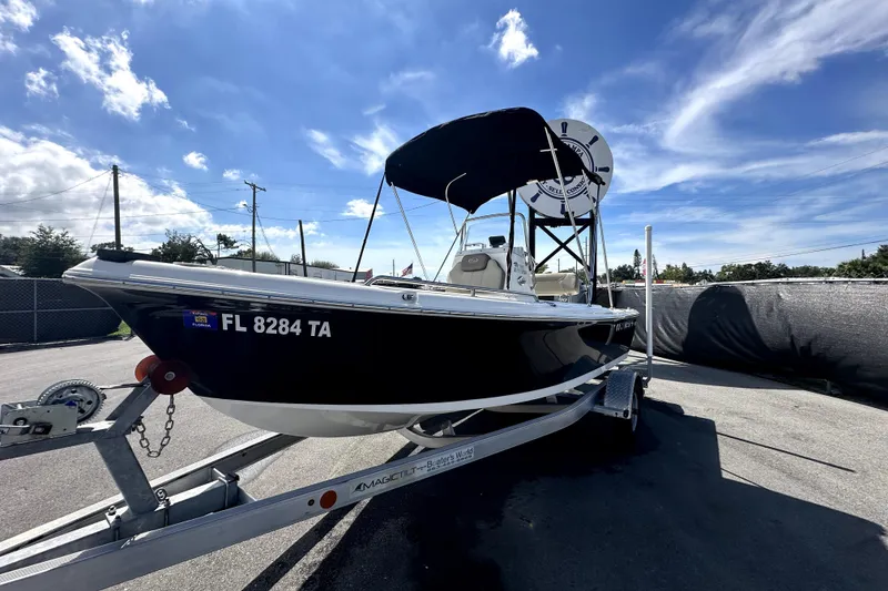 Slide: The Image of 2022 Key West 1720 Center Console with Yamaha outboard motor, parked outdoors. - 3