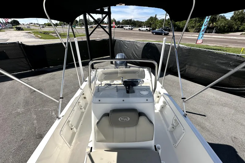 Slide: The Image of 2022 Key West 1720 Center Console boat with canopy, parked outdoors. - 31