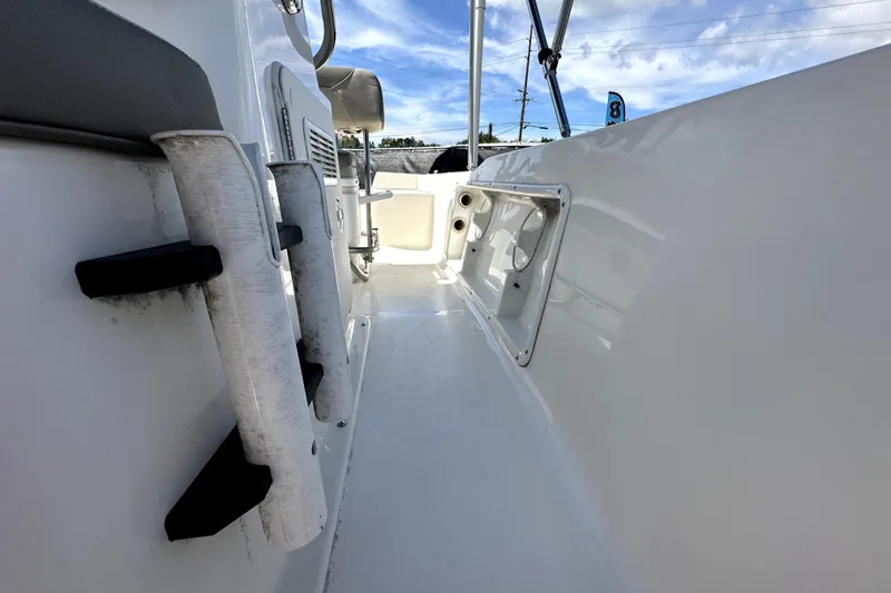 Slide: The Image of 2022 Key West 1720 Center Console boat interior with rod holders and storage compartments. - 36