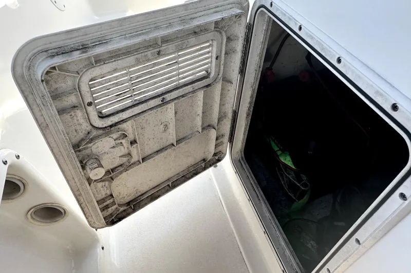 Slide: The Image of Open hatch on a 2022 Key West 1720 Center Console boat, showing interior compartment. - 37