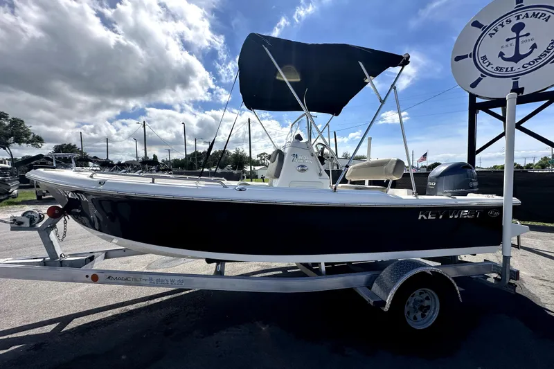 Slide: The Image of 2022 Key West 1720 Center Console boat with Yamaha 90 engine, parked outdoors. - 4