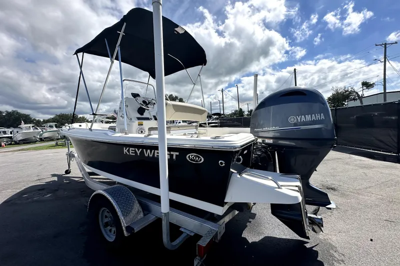 Slide: The Image of 2022 Key West 1720 Center Console boat with 90 HP engine, parked outdoors. - 5