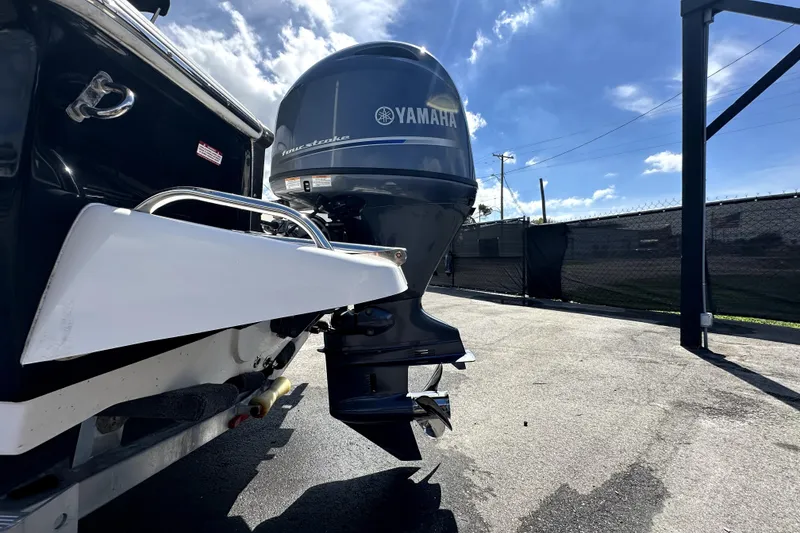 Slide: The Image of 2022 Key West 1720 Center Console boat on trailer, showing propeller and rear view. - 6