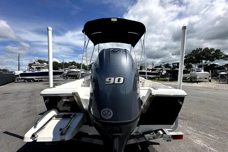 Slide: The Image of 2022 Key West 1720 Center Console boat with Yamaha engine on trailer, under cloudy sky. - 8