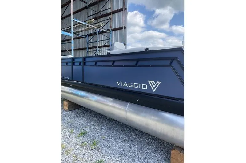 Slide: The Image of 2025 Viaggio Lago V-U pontoon boat in storage, featuring sleek design and branding. - 3