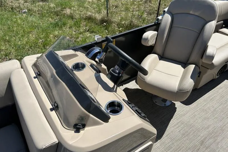 Slide: The Image of 2024 Bentley Pontoons LE 200 CW interior with beige captain's chair and steering console. - 10
