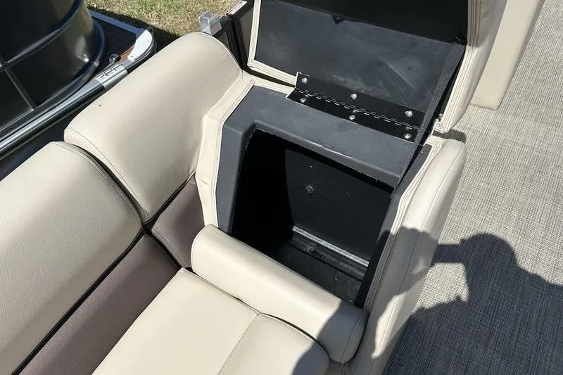 Slide: The Image of 2024 Bentley Pontoons LE 200 CW seat storage compartment open, showcasing interior space. - 11