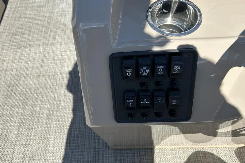 Slide: The Image of Control panel of 2024 Bentley Pontoons LE 200 CW with cup holder and switches. - 17