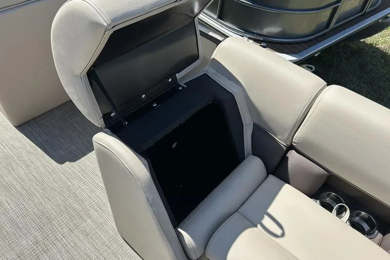 Slide: The Image of 2024 Bentley Pontoons LE 200 CW interior storage compartment with beige seating and cup holders. - 18