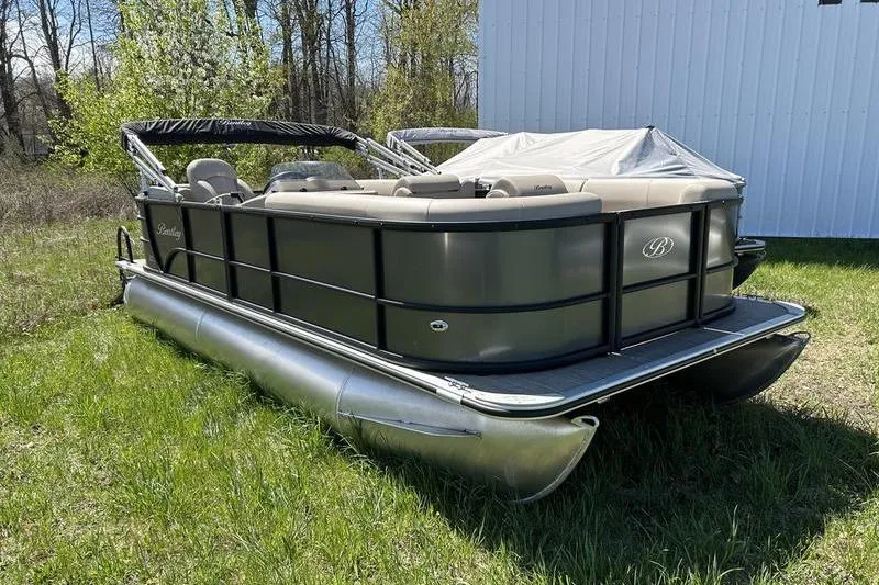 Slide: The Image of 2024 Bentley Pontoons LE 200 CW on grass, showcasing sleek design and modern features. - 4