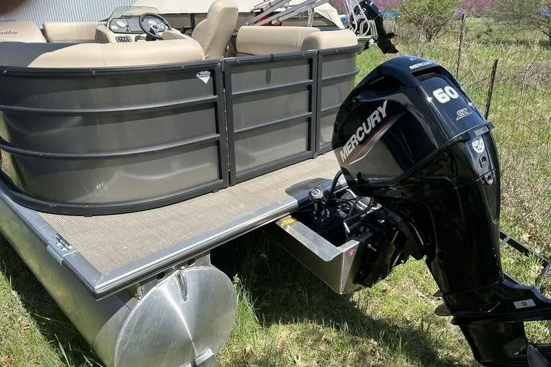 Slide: The Image of 2024 Bentley Pontoons LE 200 CW with Mercury 60 outboard motor in grassy area. - 6