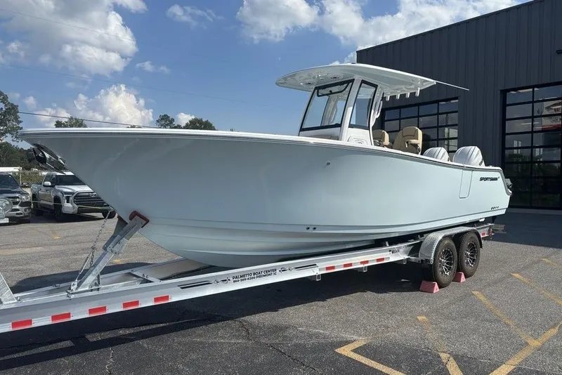 The Image of 2026 Sportsman Heritage 261 Center Console boat on trailer, parked outdoors. - 1