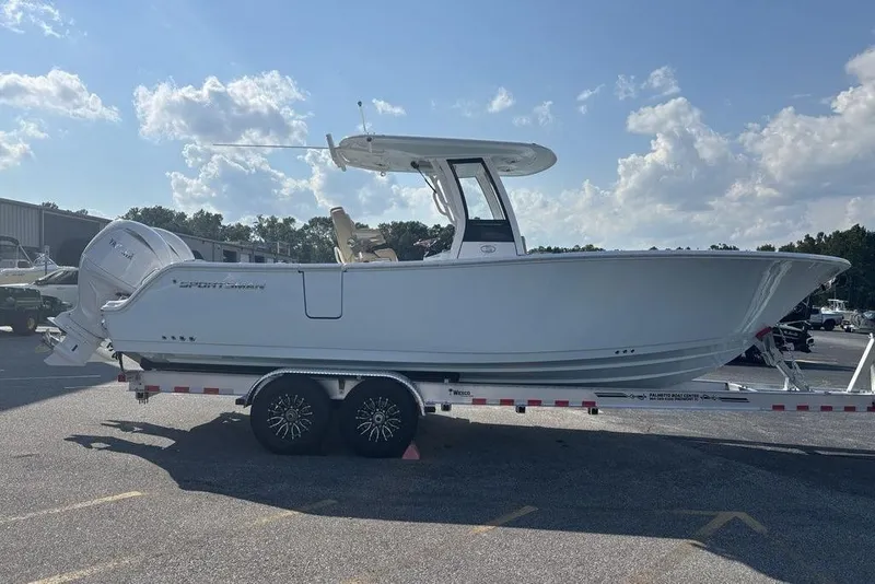 Slide: The Image of 2026 Sportsman Heritage 261 Center Console boat on trailer under a sunny sky. - 11