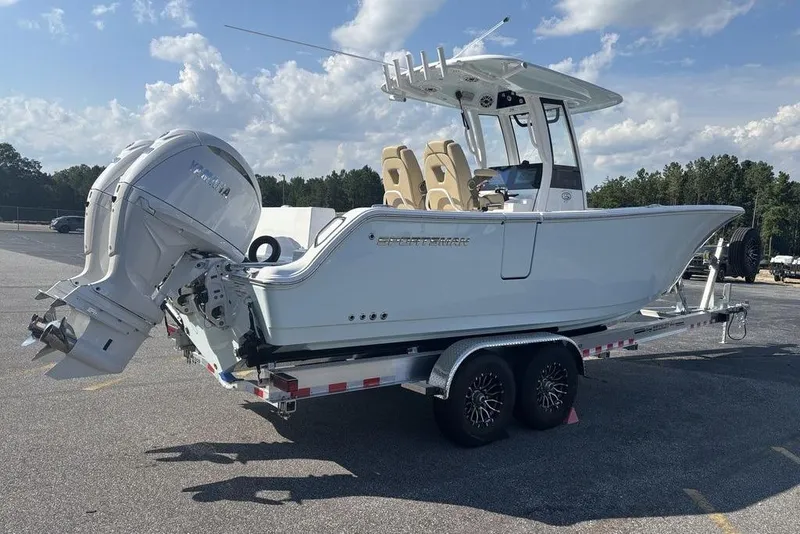 Slide: The Image of 2026 Sportsman Heritage 261 Center Console boat on trailer, parked outdoors under a cloudy sky. - 13