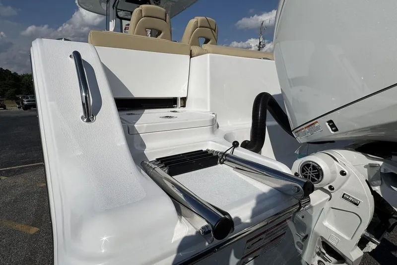Slide: The Image of 2026 Sportsman Heritage 261 Center Console boat with sleek white design and modern features. - 14