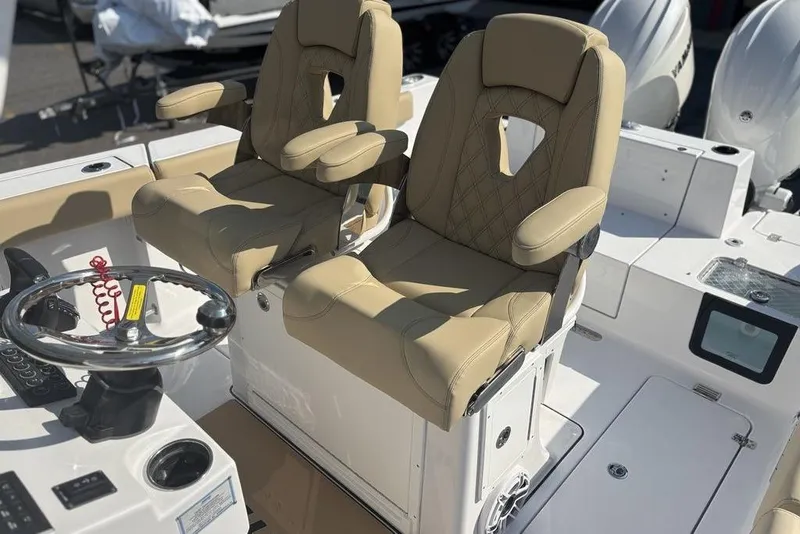 Slide: The Image of 2026 Sportsman Heritage 261 Center Console with beige captain seats and steering wheel. - 19