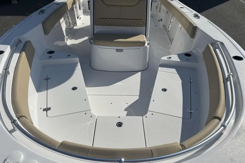 Slide: The Image of 2026 Sportsman Heritage 261 Center Console boat interior with cushioned seating and storage compartments. - 21