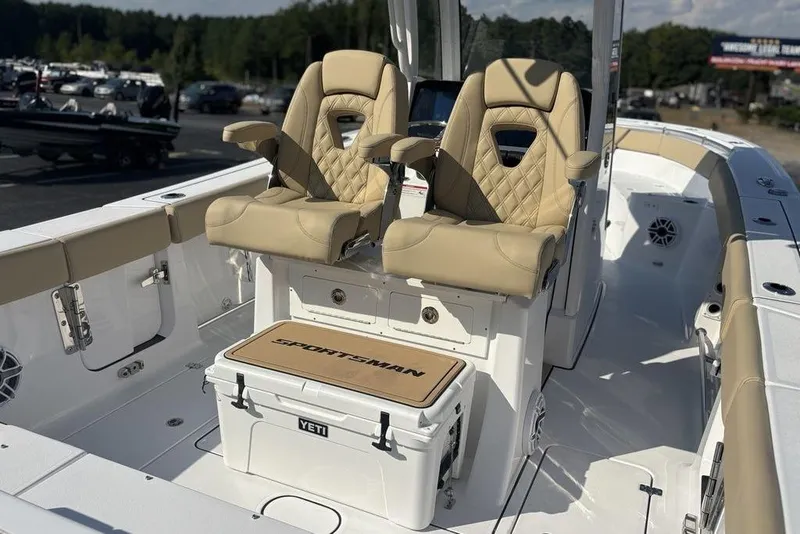 Slide: The Image of 2026 Sportsman Heritage 261 Center Console boat with beige seating and Yeti cooler. - 23