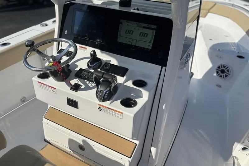 Slide: The Image of 2026 Sportsman Heritage 261 Center Console boat dashboard with steering wheel and controls. - 25