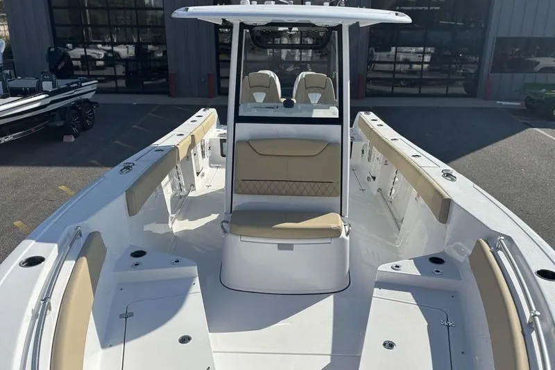 Slide: The Image of 2026 Sportsman Heritage 261 Center Console boat with beige seating and sleek design. - 28