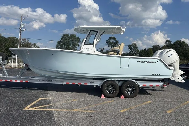 Slide: The Image of 2026 Sportsman Heritage 261 Center Console boat on trailer, parked outdoors. - 4
