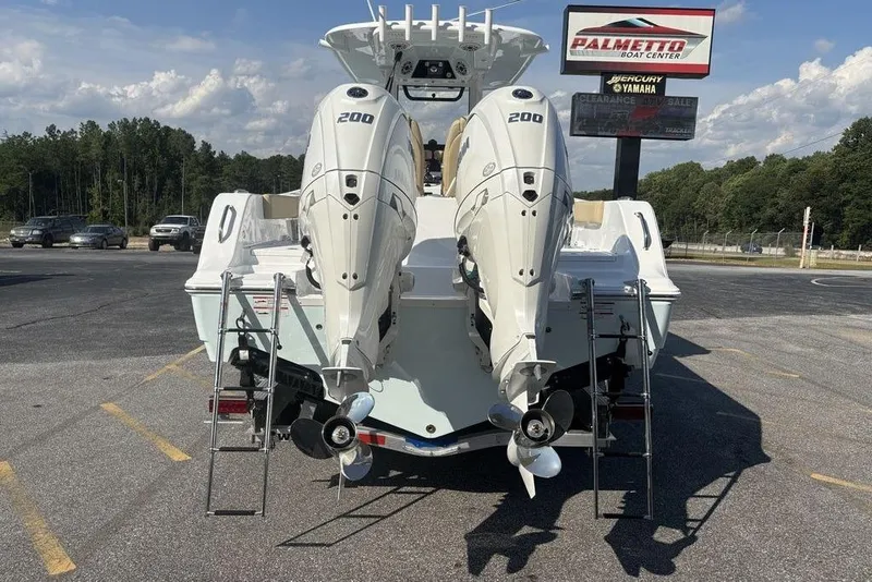 Slide: The Image of 2026 Sportsman Heritage 261 Center Console with dual 200 horsepower engines at a boat center. - 5