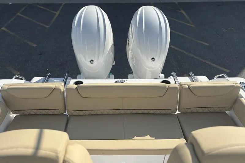 Slide: The Image of 2026 Sportsman Heritage 261 Center Console boat with dual engines and beige seating. - 6