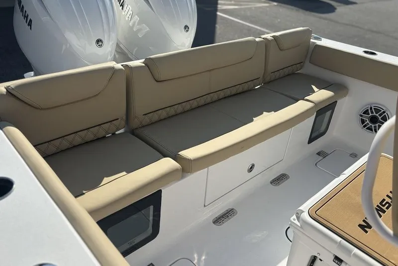 Slide: The Image of 2026 Sportsman Heritage 261 Center Console boat with beige seating and Yamaha engines. - 7