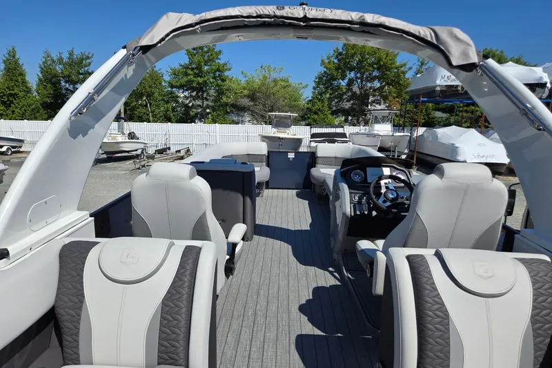 Slide: The Image of 2025 Godfrey Monaco 255 SB pontoon boat interior with luxurious seating and modern helm. - 29