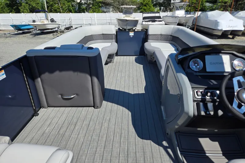 Slide: The Image of 2025 Godfrey Monaco 255 SB pontoon boat interior with modern seating and Garmin dashboard. - 32