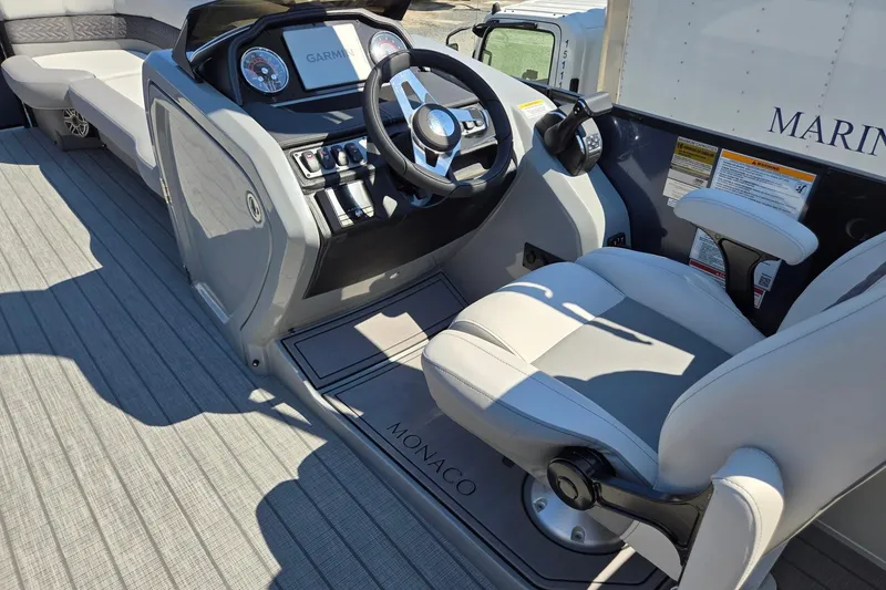 Slide: The Image of 2025 Godfrey Monaco 255 SB boat helm with modern controls and comfortable seating. - 34