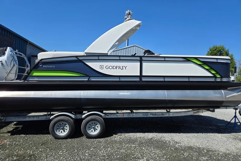 Slide: The Image of 2025 Godfrey Monaco 255 SB pontoon boat on trailer, featuring sleek design and modern accents. - 7