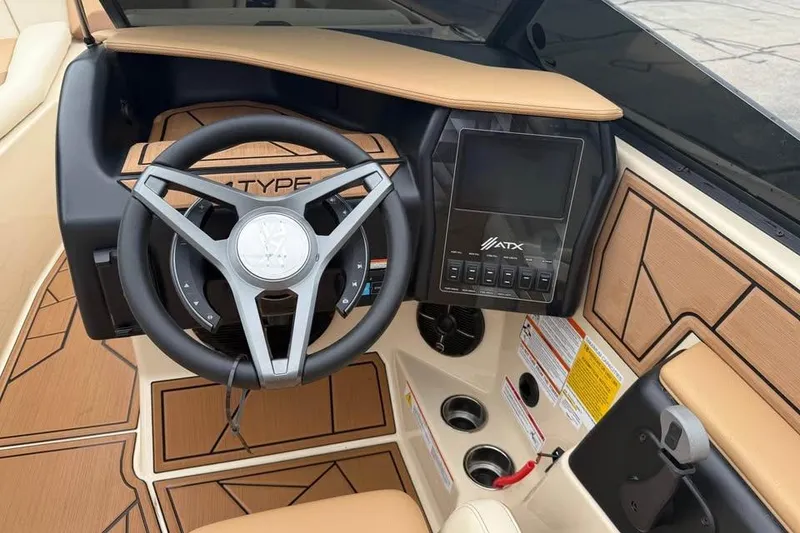 Slide: The Image of 2024 ATX Surf Boats 24 Type-S dashboard with steering wheel and touchscreen display. - 11