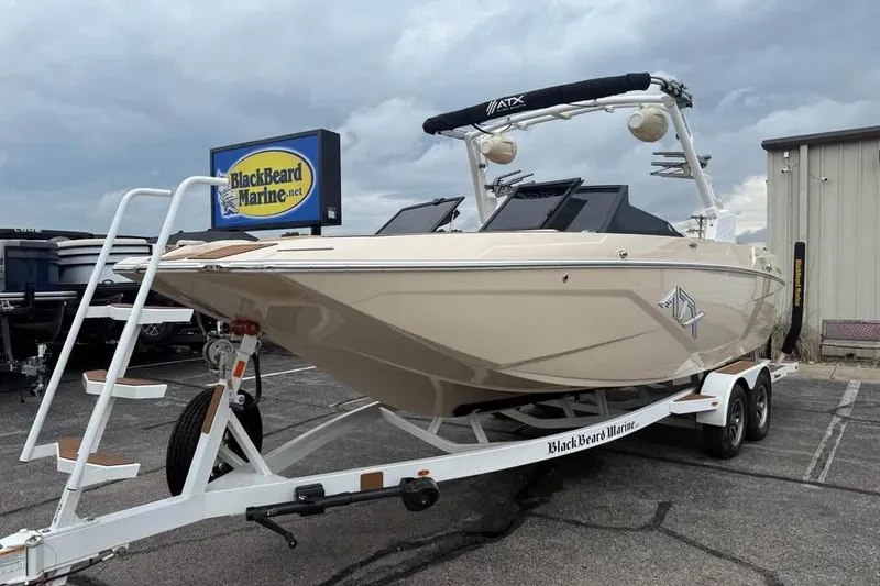 Slide: The Image of 2024 ATX Surf Boats 24 Type-S on trailer at BlackBeard Marine dealership. - 2