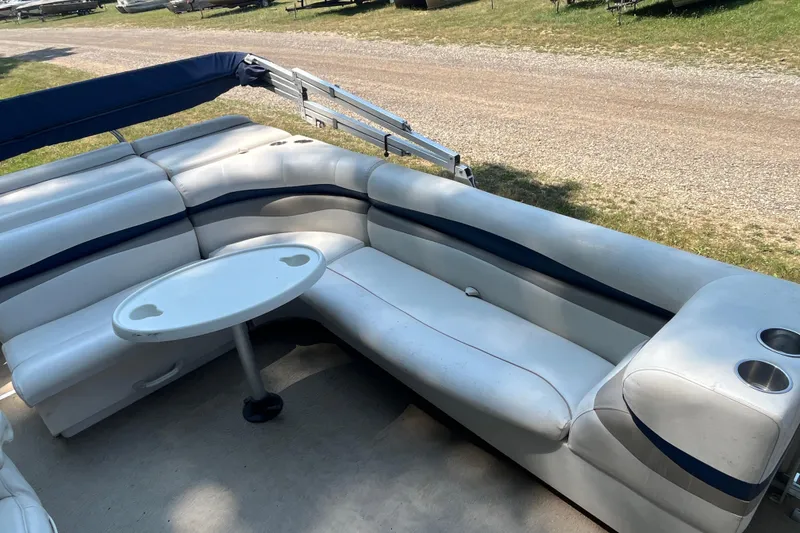 Slide: The Image of 2007 Harris-Kayot Super Sunliner 220 O/B boat interior with white seating and table. - 12