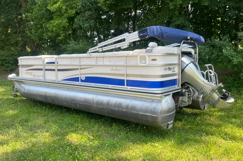 Slide: The Image of 2007 Harris-Kayot Super Sunliner 220 O/B pontoon boat on grassy area, surrounded by trees. - 3