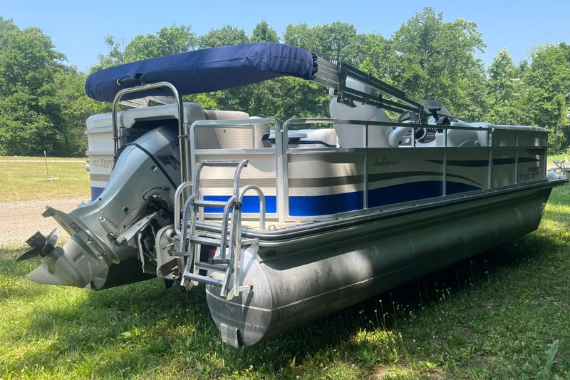 Slide: The Image of 2007 Harris-Kayot Super Sunliner 220 O/B pontoon boat on grass, with outboard motor. - 5