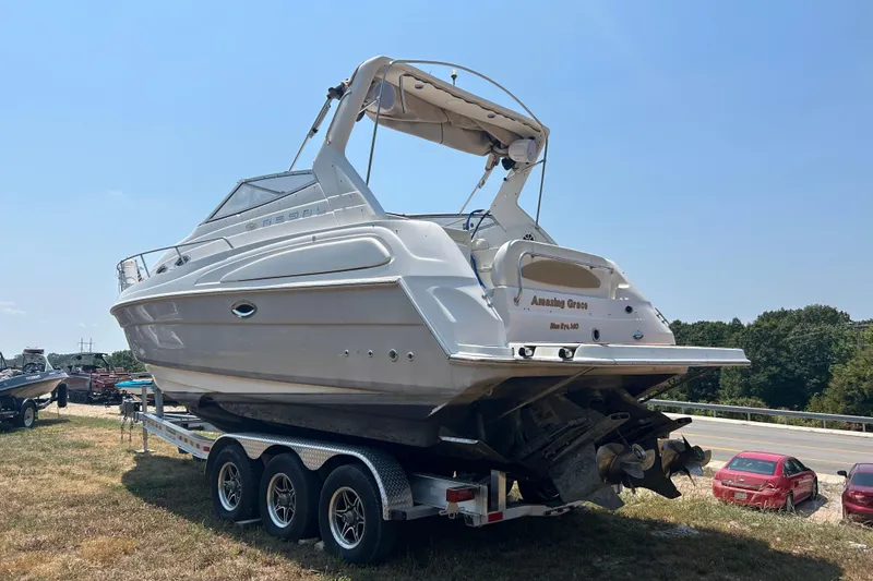 Slide: The Image of 2003 Regal Commodore 2860 boat on trailer, parked outdoors under clear sky. - 4